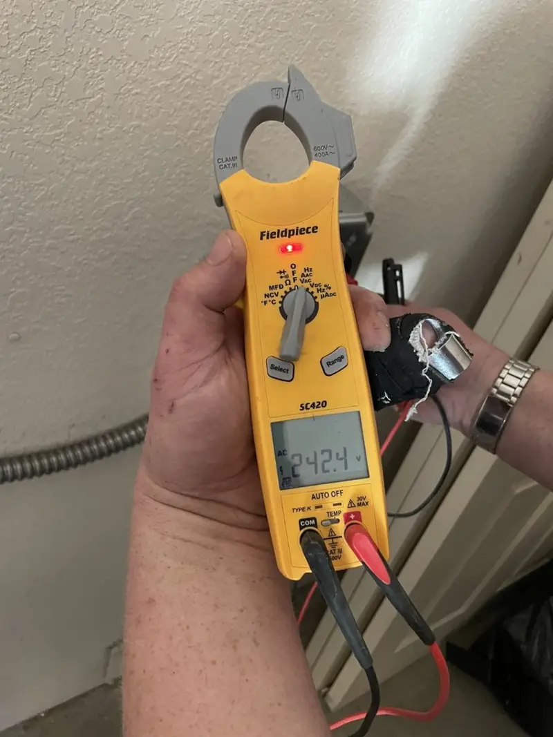 Voltage testing with clamp meter during Outlet Installation in Manning